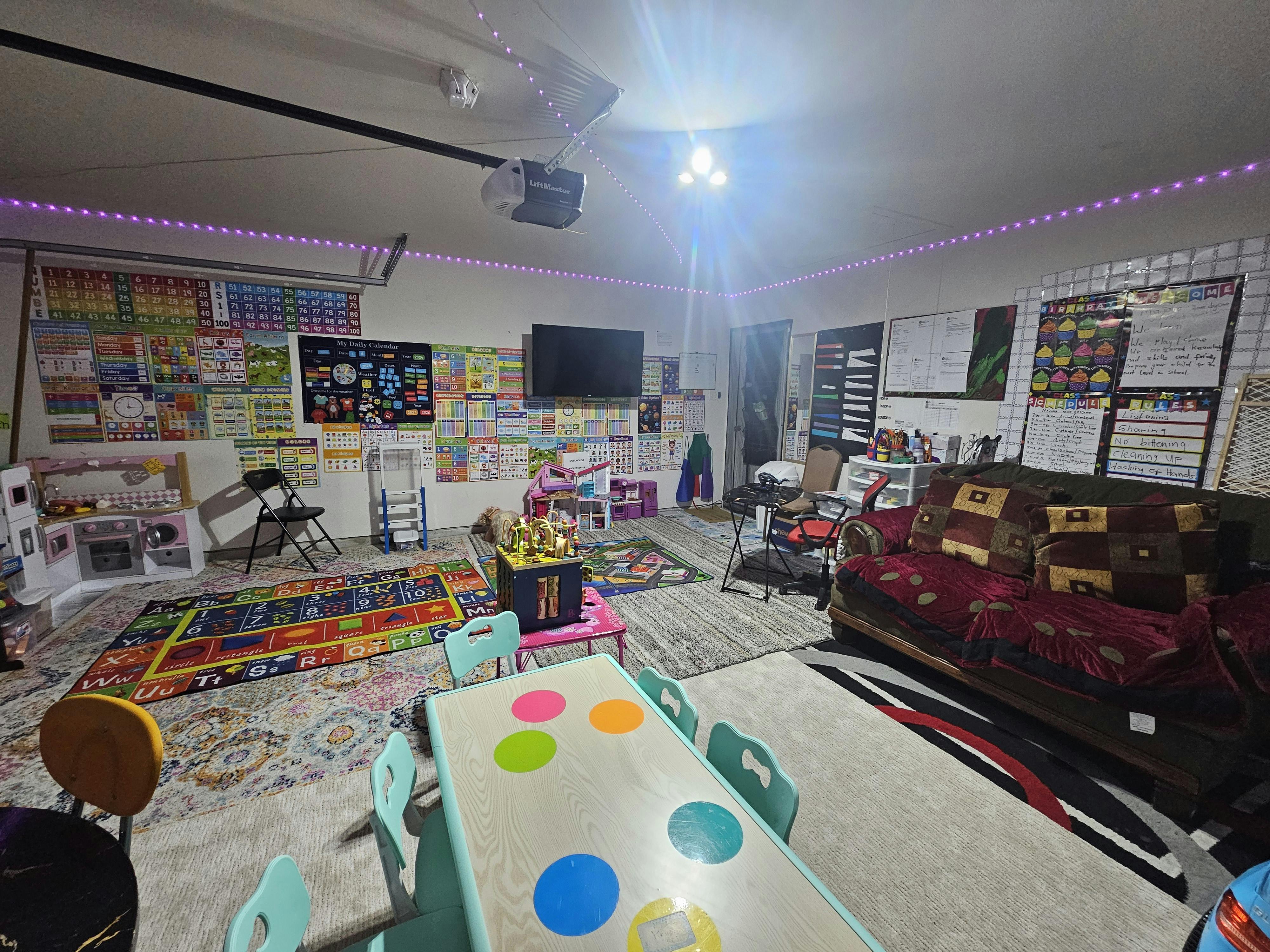 Room with a children's play area and a sofa