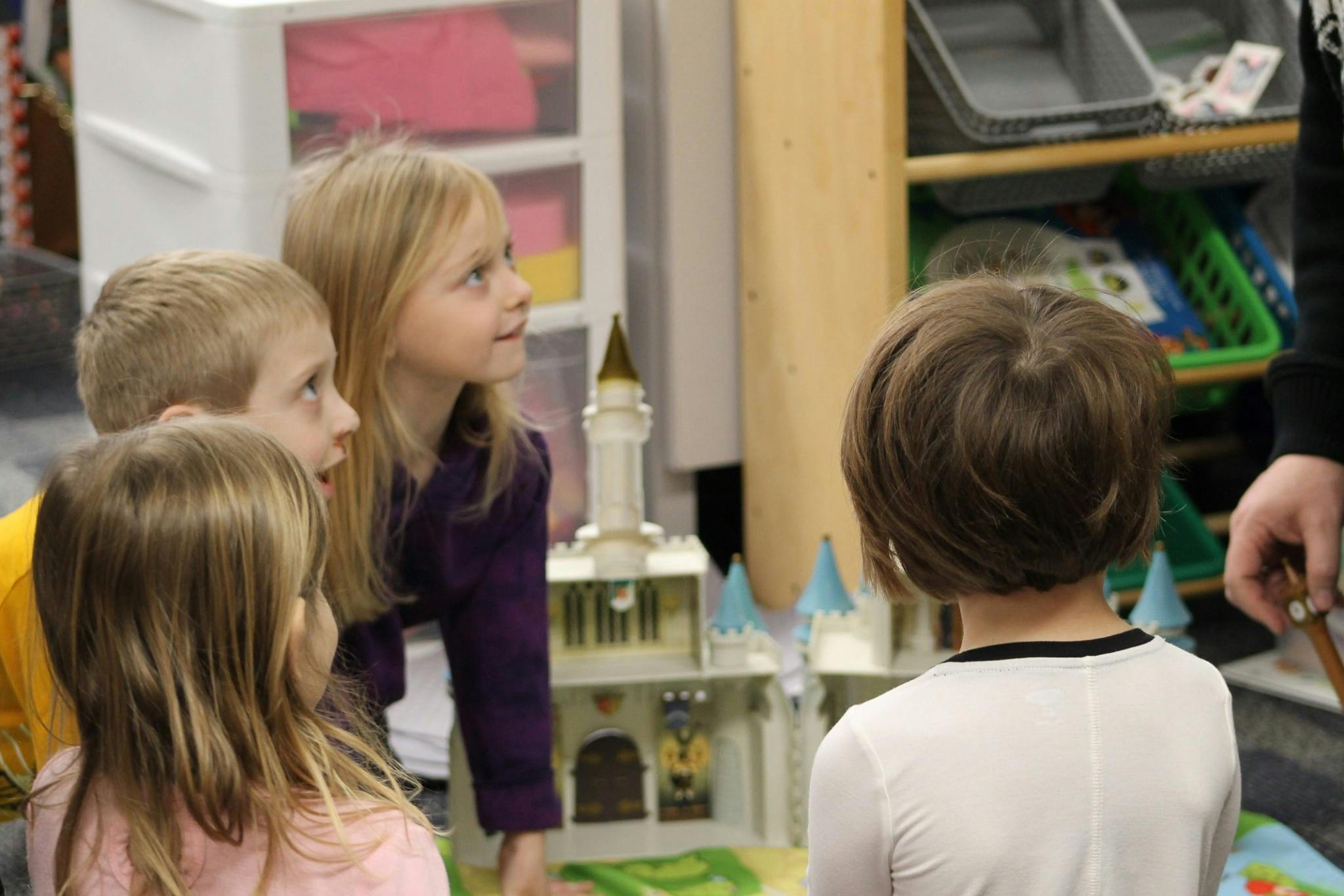 Children looking at a toy castle