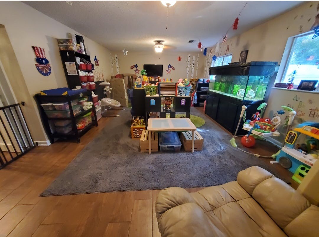 Playroom with toys, shelves, a small table, and an aquarium