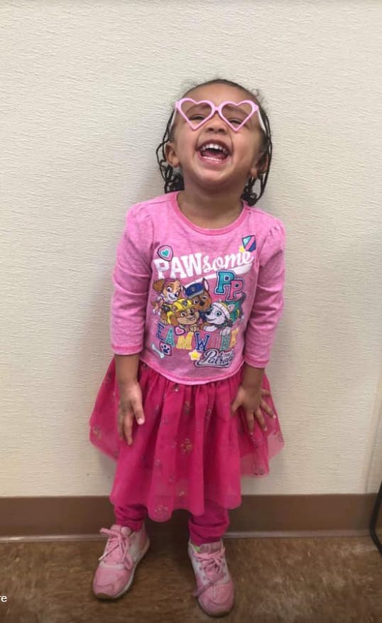 Child wearing heart-shaped glasses and a shirt with "PAWsome" text