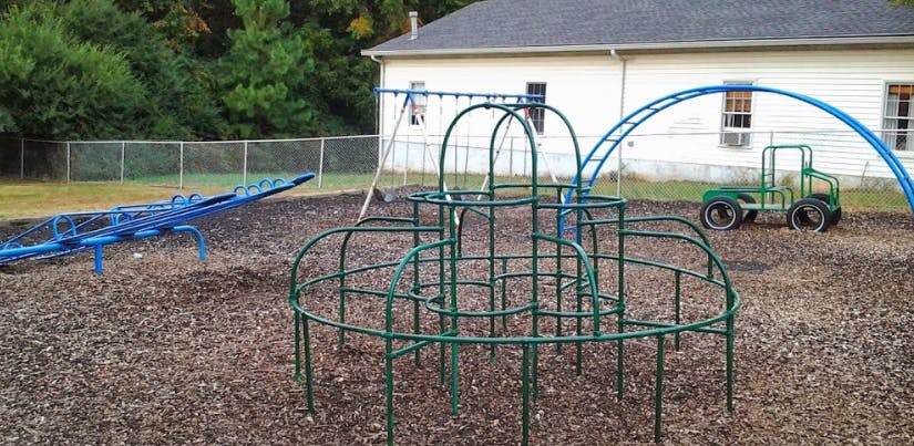 Playground with a climbing dome, seesaw, and swing set