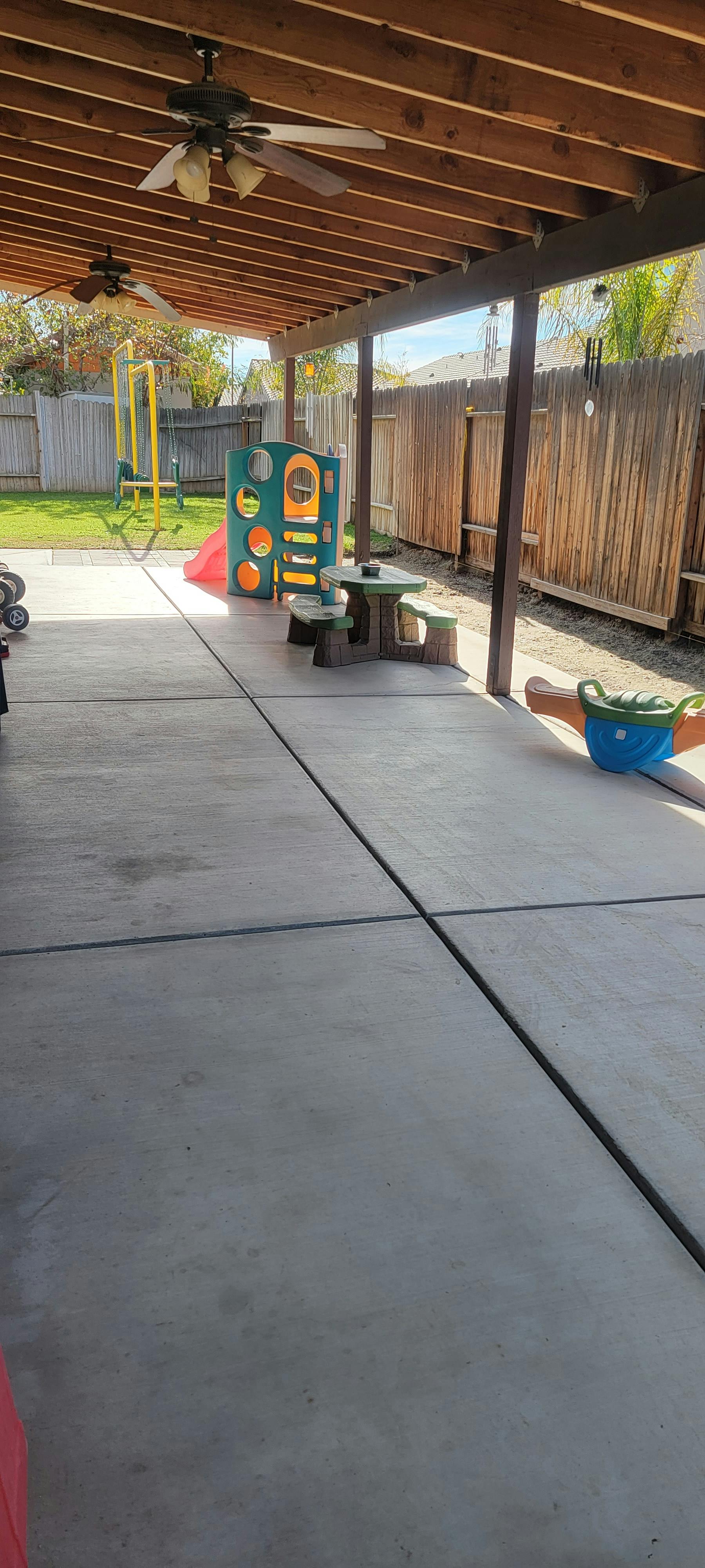 Patio with children's play structure and picnic table