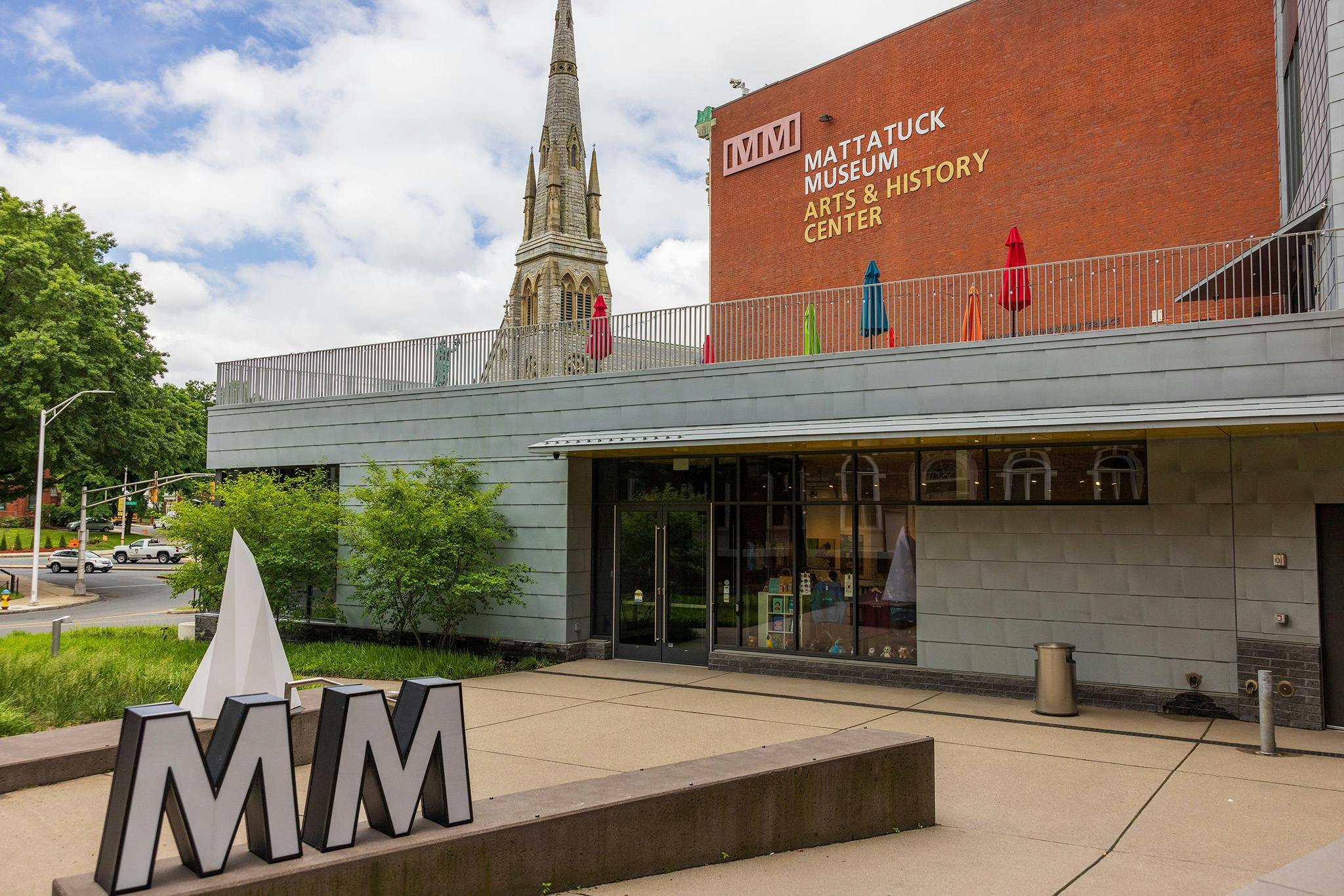 MUSEUM ARTS & HISTORY CENTER building with a church steeple behind it