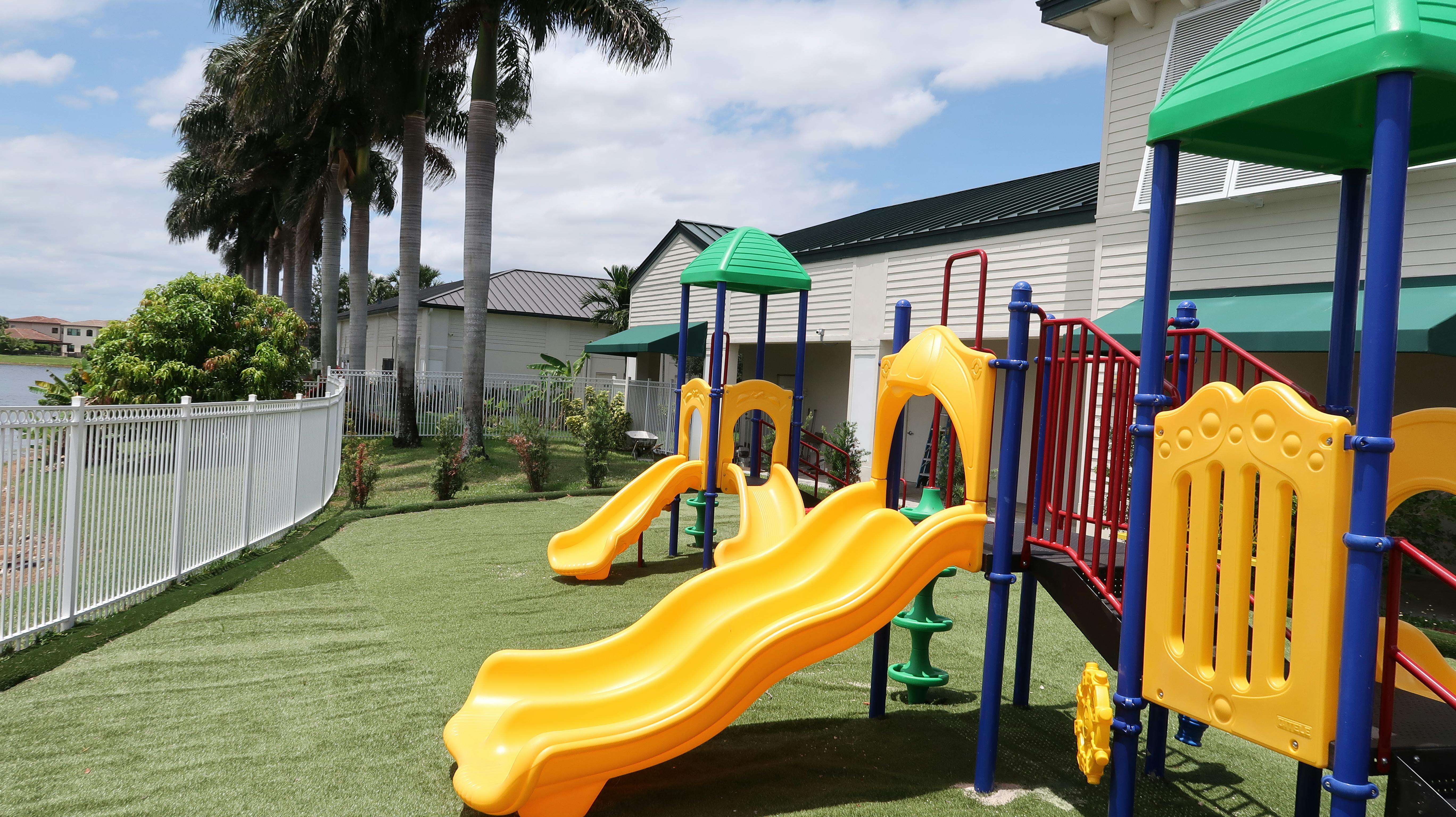 Playground with yellow slides and green and blue structures
