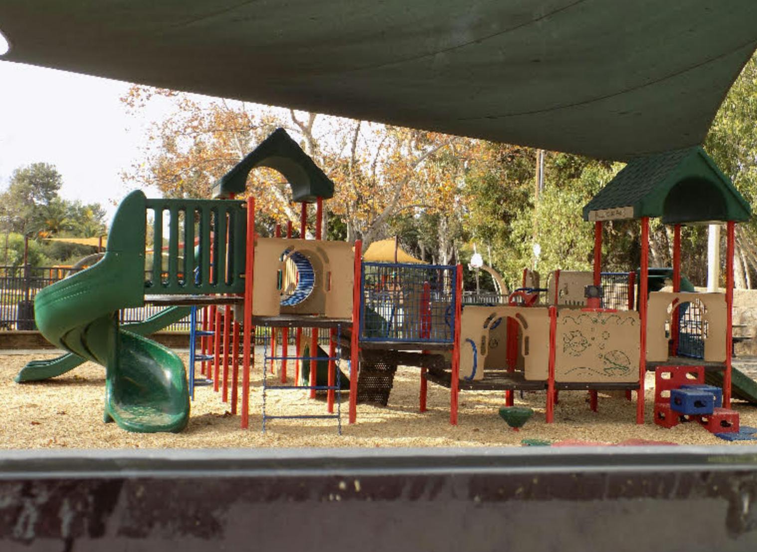Playground structure with slides and climbing areas on sand