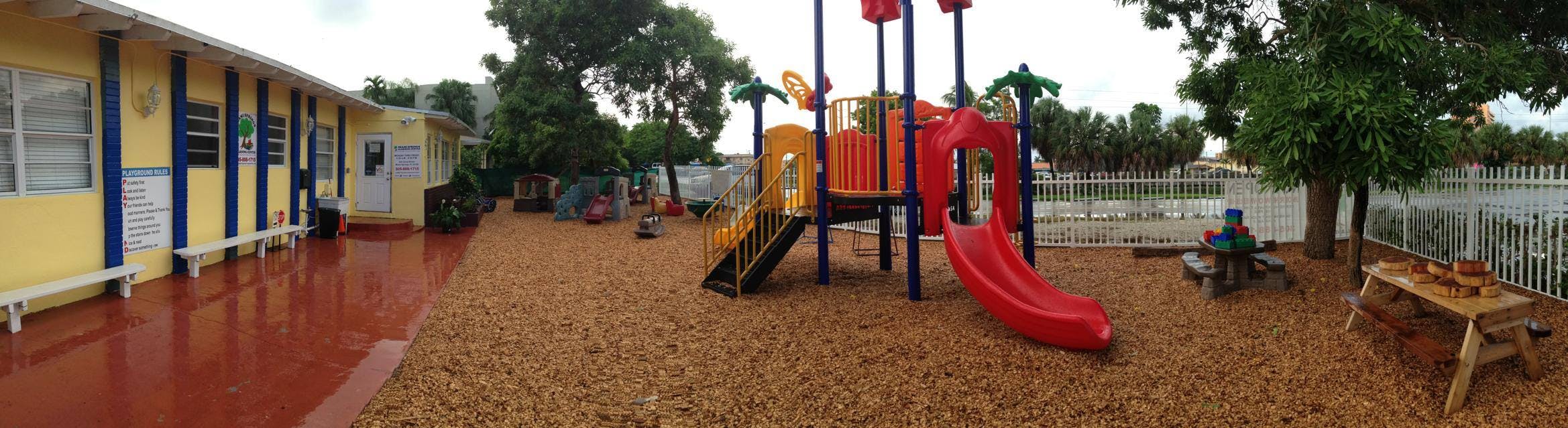 Playground with slides and swings next to a building