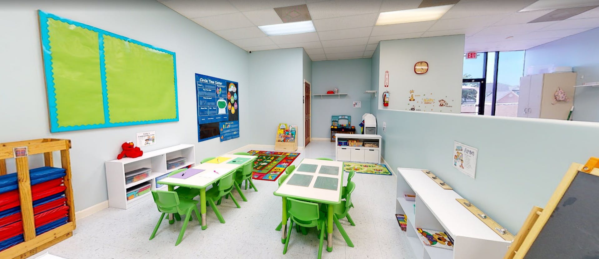 Classroom with small green tables and chairs