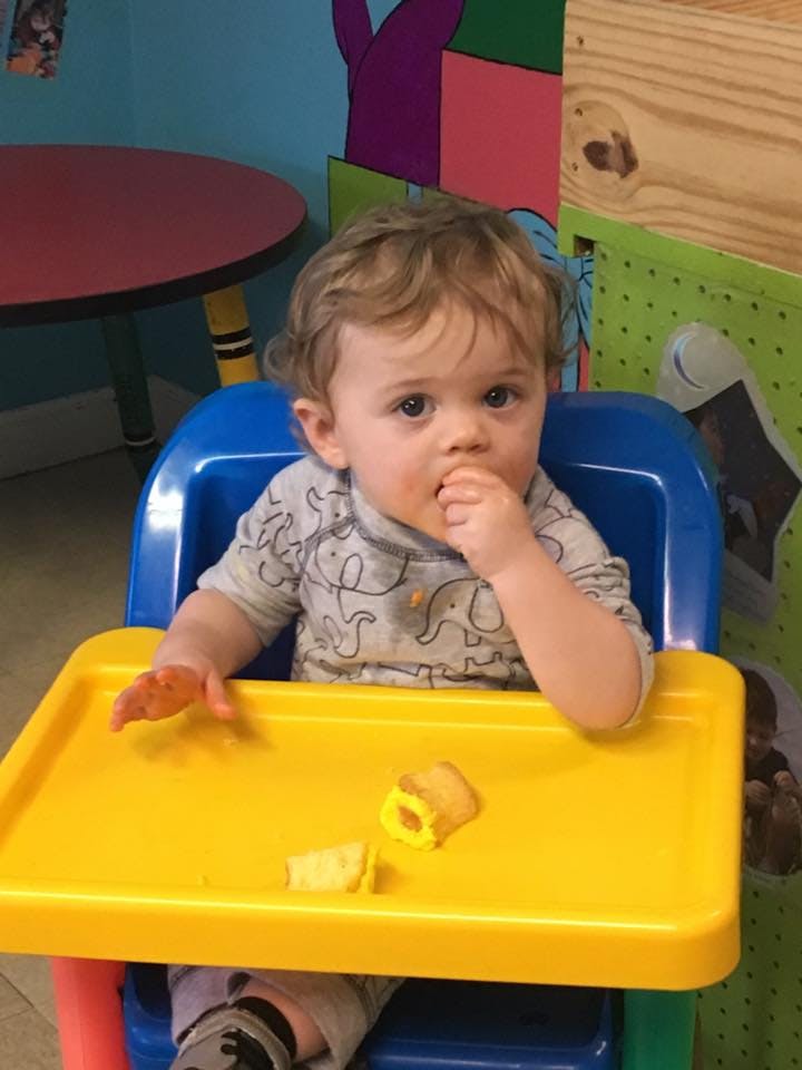 Child in a high chair eating