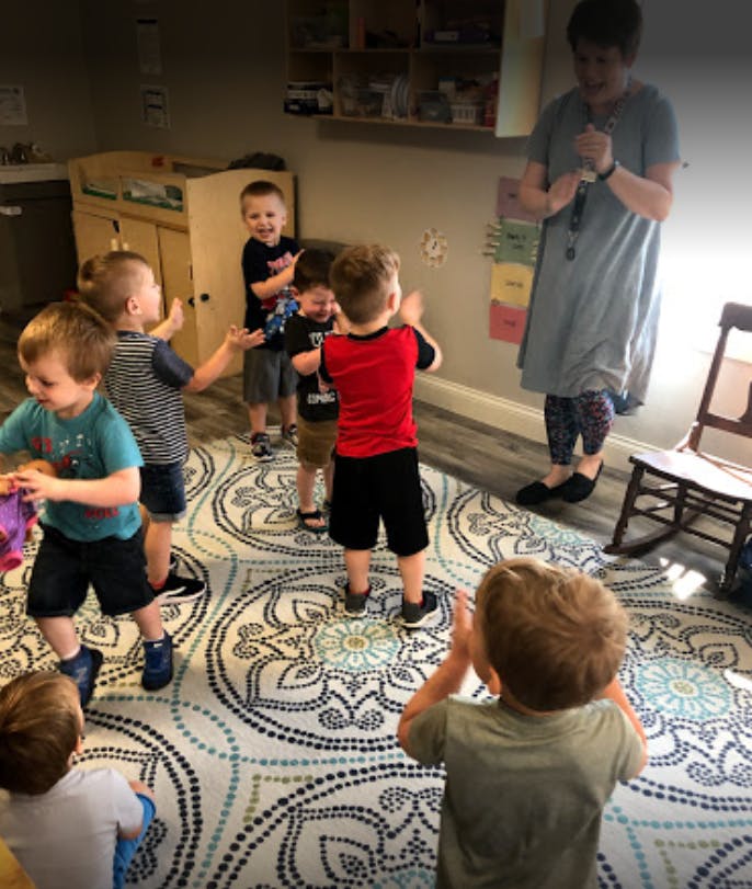 Adult and children playing in a room