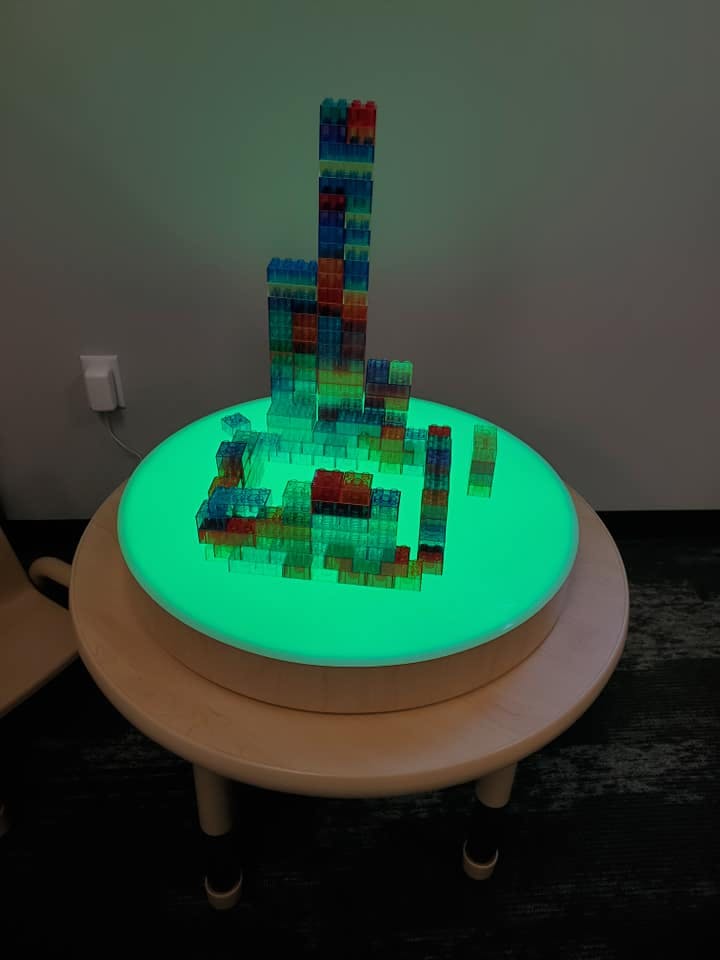 Building blocks on a glowing green light table