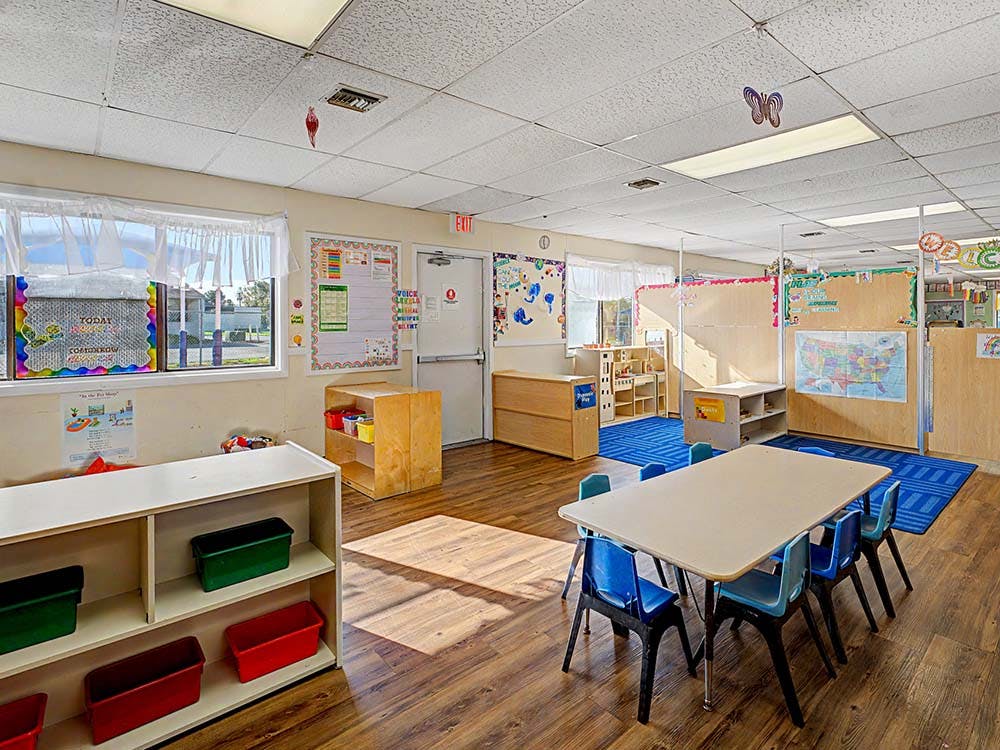 Empty classroom with small tables and chairs