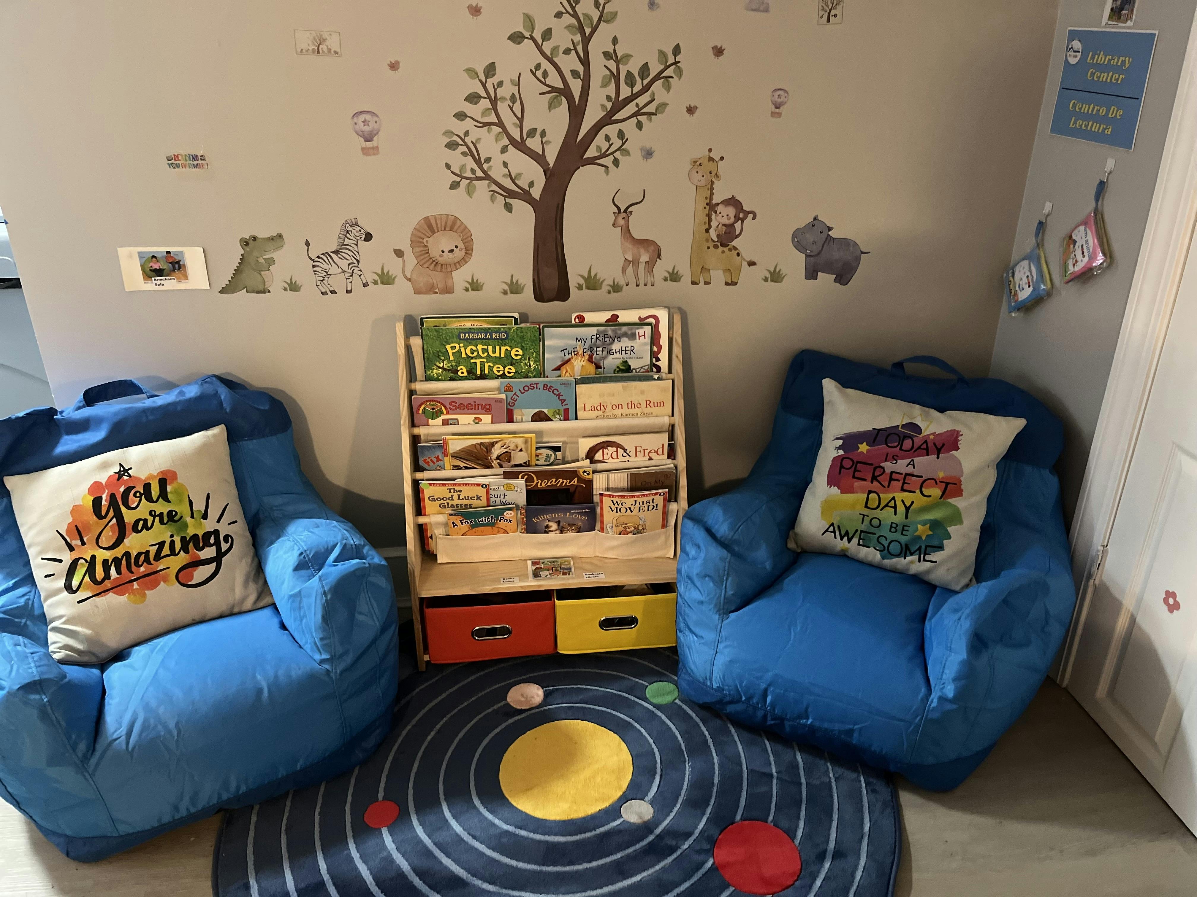 Two blue bean bag chairs flanking a wooden book display shelf