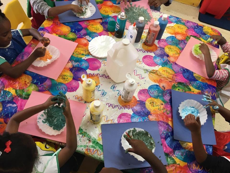 Children doing an art project at a table