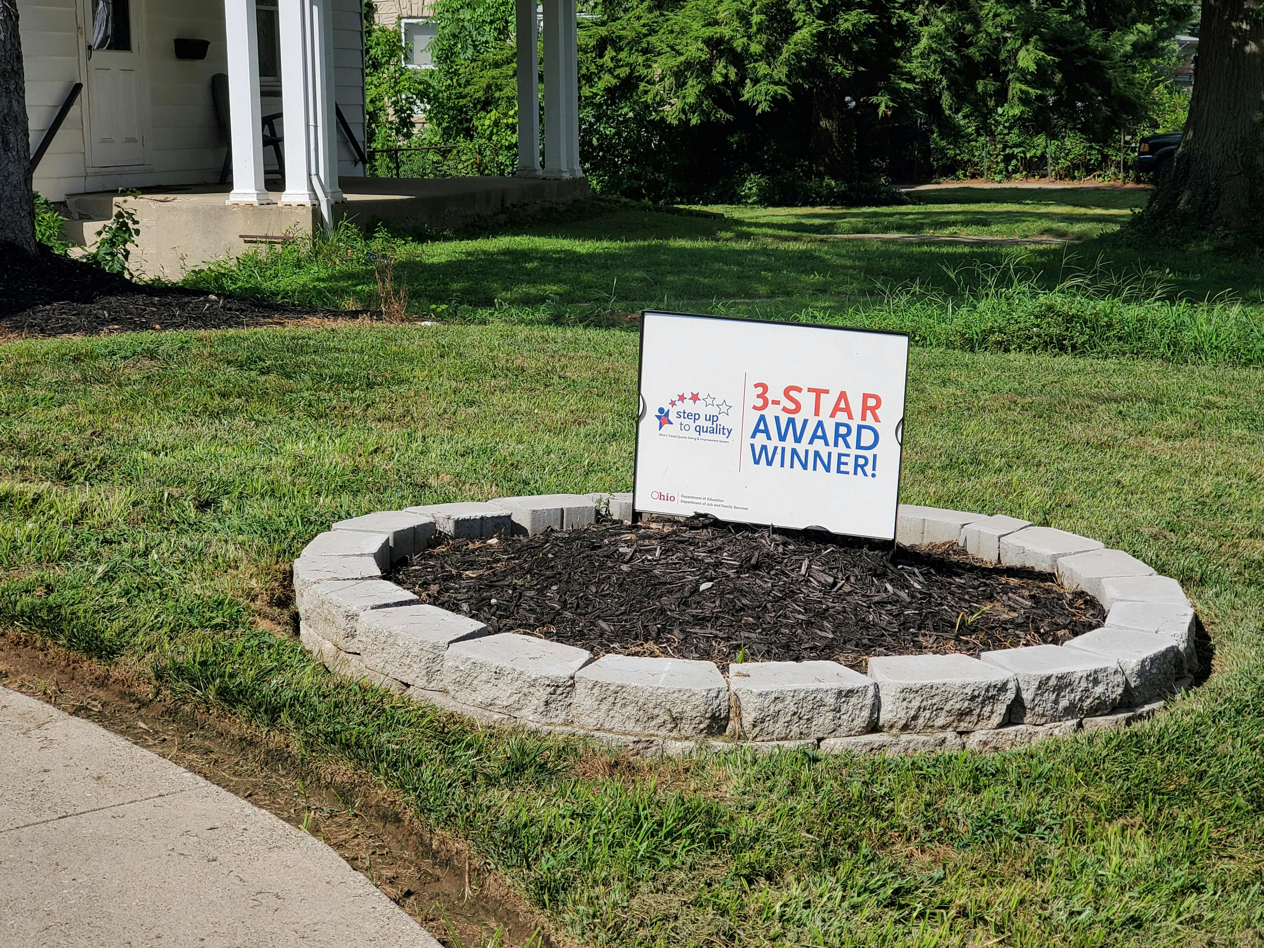 Sign in a stone planter that reads "3-STAR AWARD WINNER"