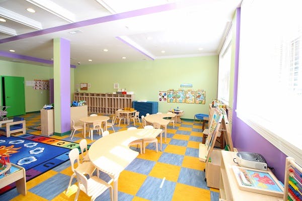 Empty classroom with small tables and chairs