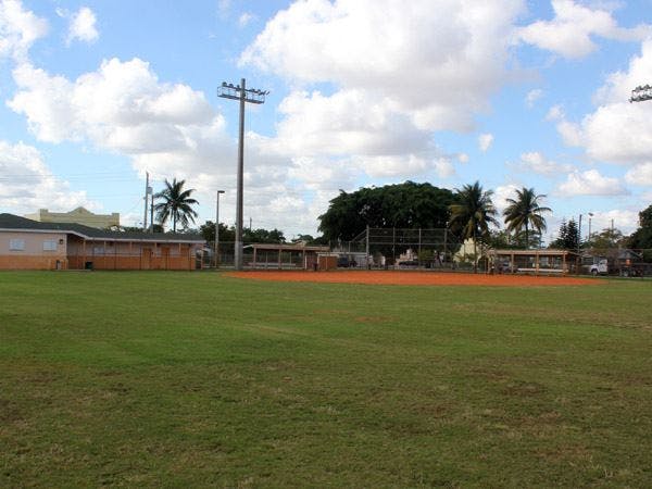 Baseball field with green grass and dirt infield