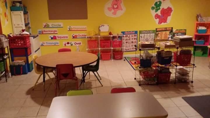 Classroom with tables, chairs, and storage shelves