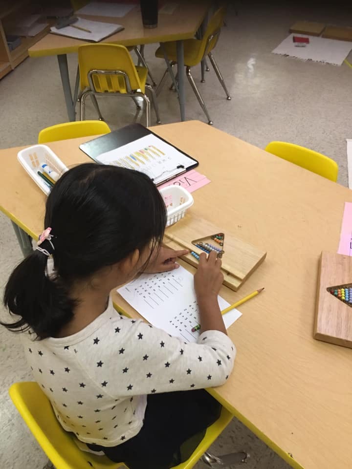 Child working at a desk in a classroom