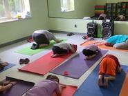 Children doing yoga on mats in a room