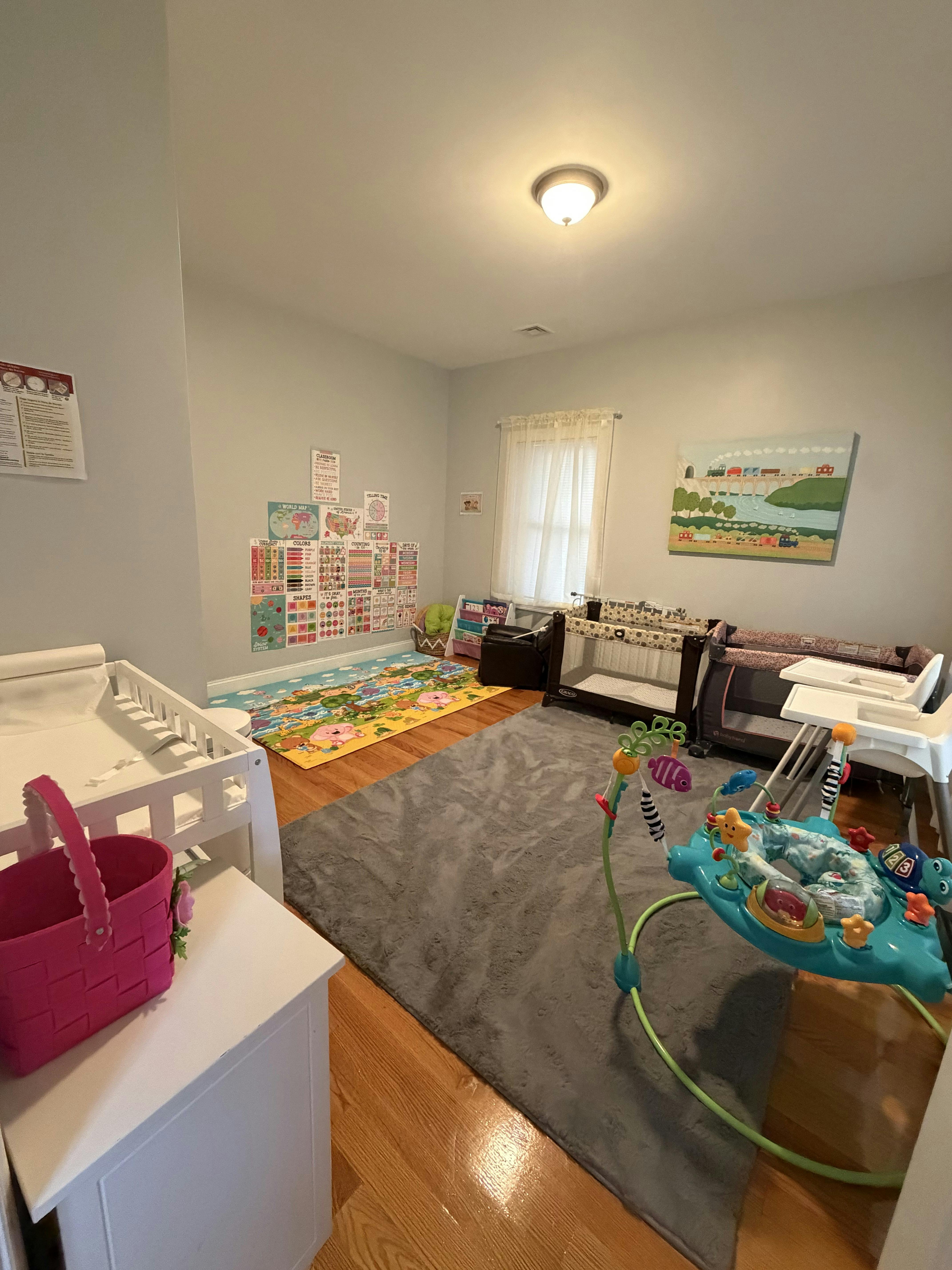 Child nursery with play mats, playpens, and activity toys