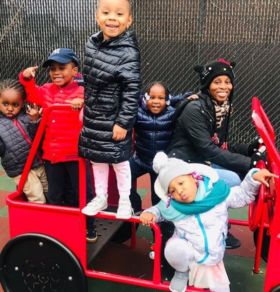 Adult and children in a red play car