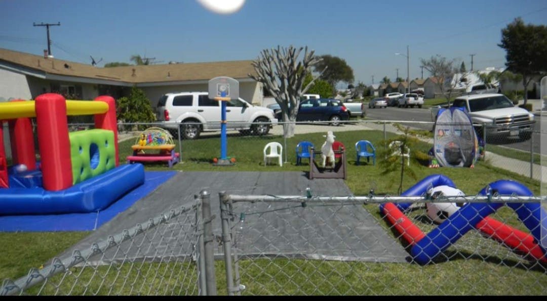 Inflatable bounce house and play equipment in a yard