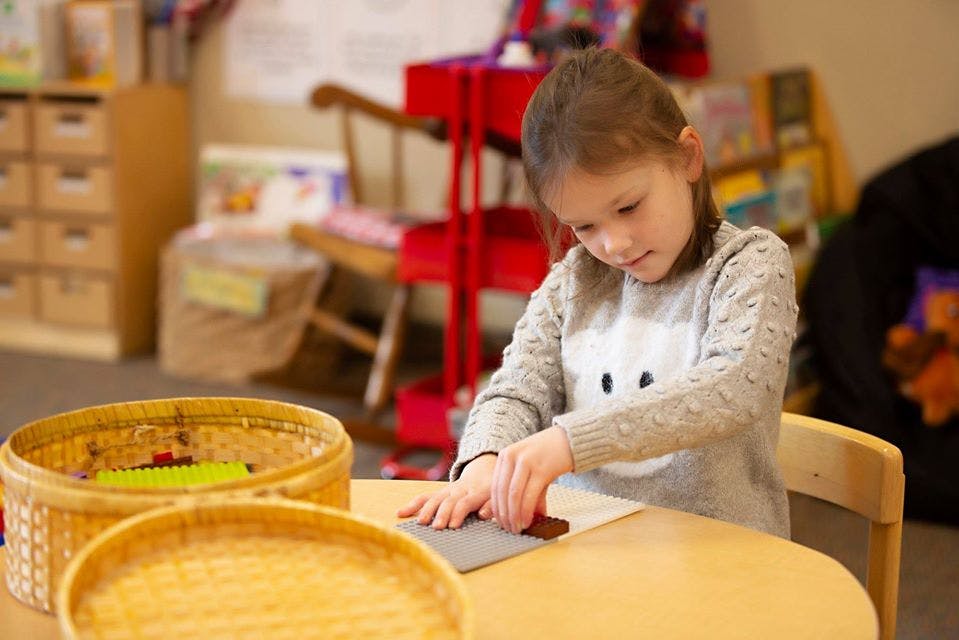Child working on a craft at a table