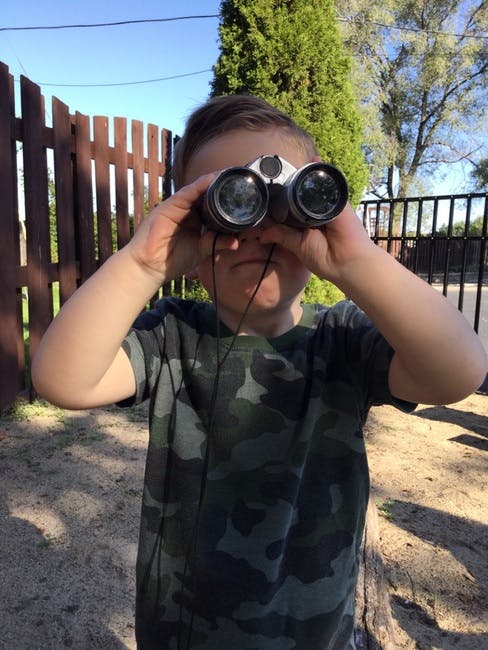 Child looking through binoculars