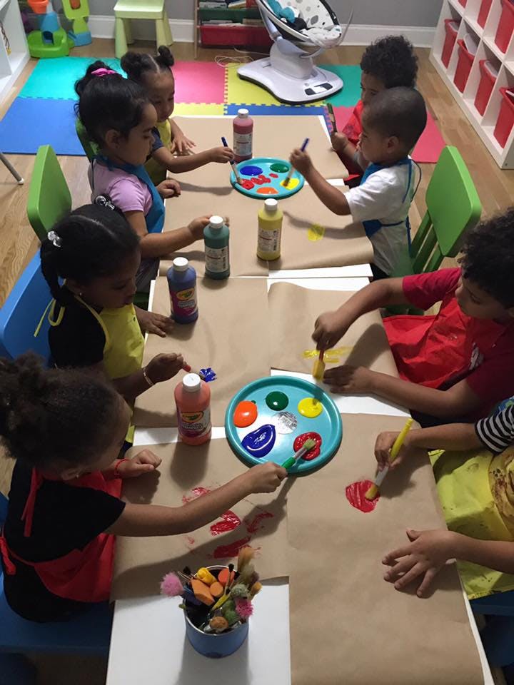Children painting at a table