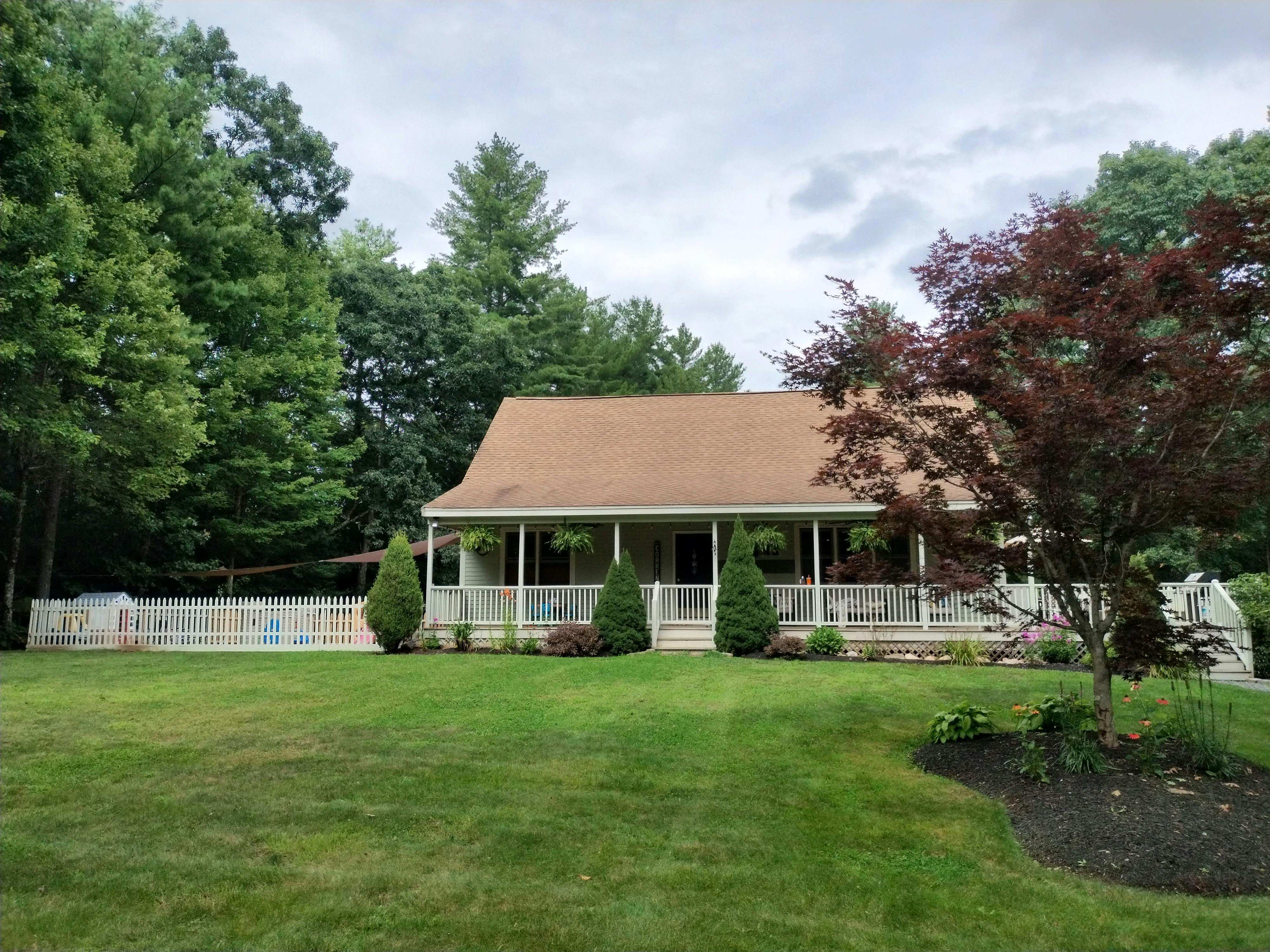 House with a porch and a large front yard
