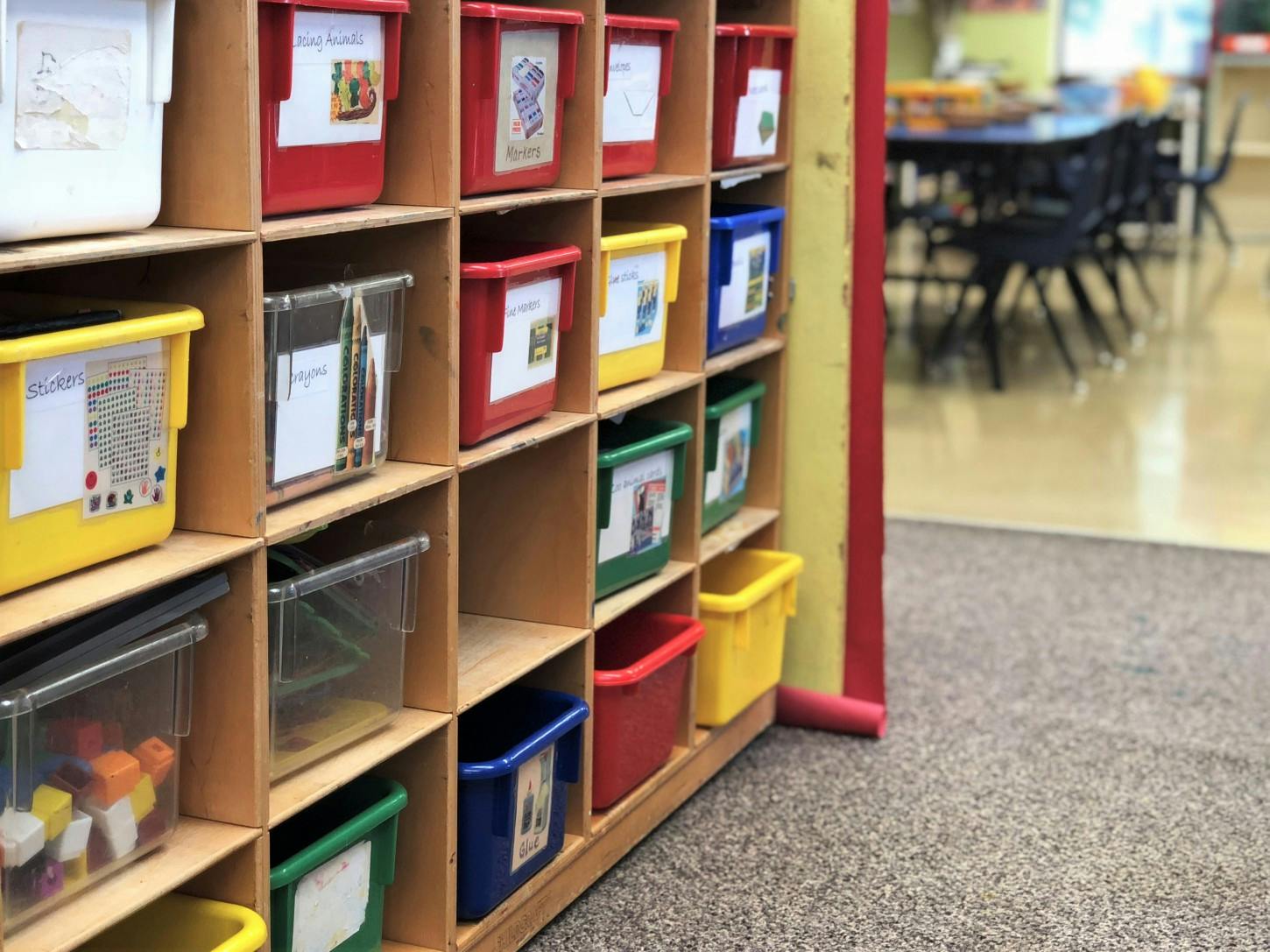 Storage cubbies with colorful bins in a classroom