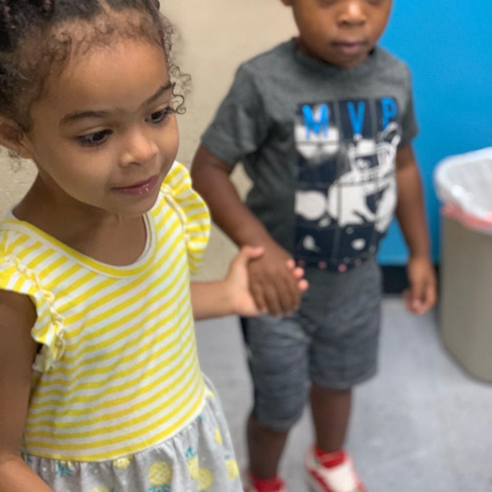 Two children holding hands