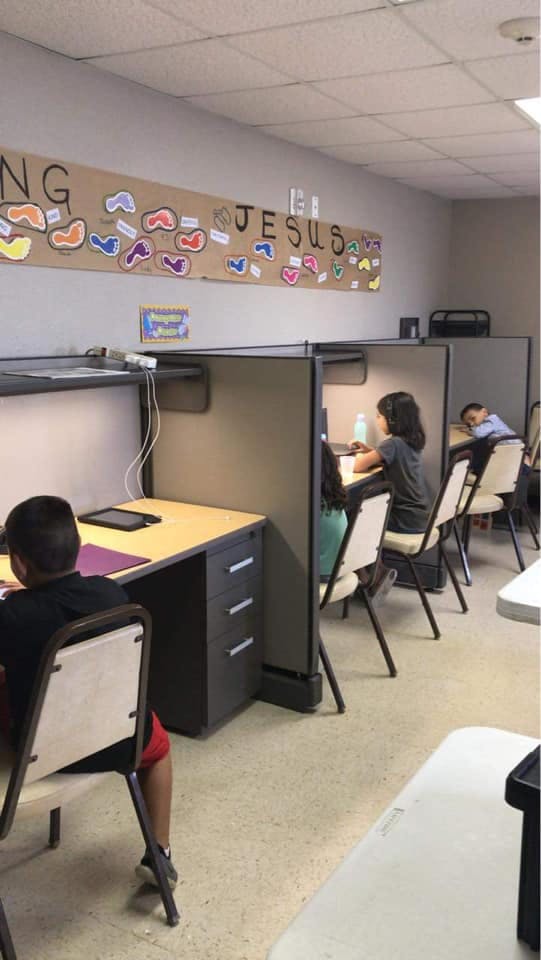 Children sitting at individual desks in a classroom