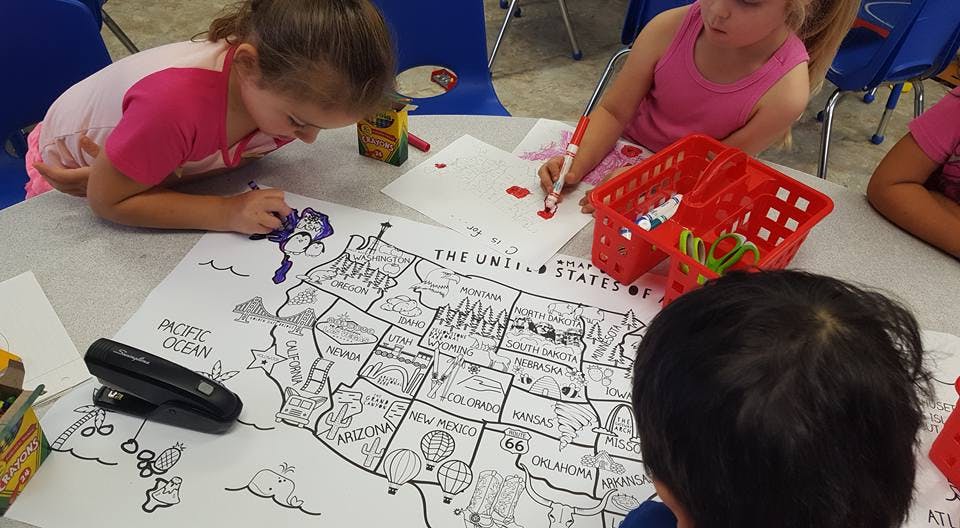 Children coloring a map of the United States