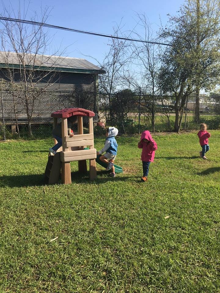 Children playing on a small outdoor play structure