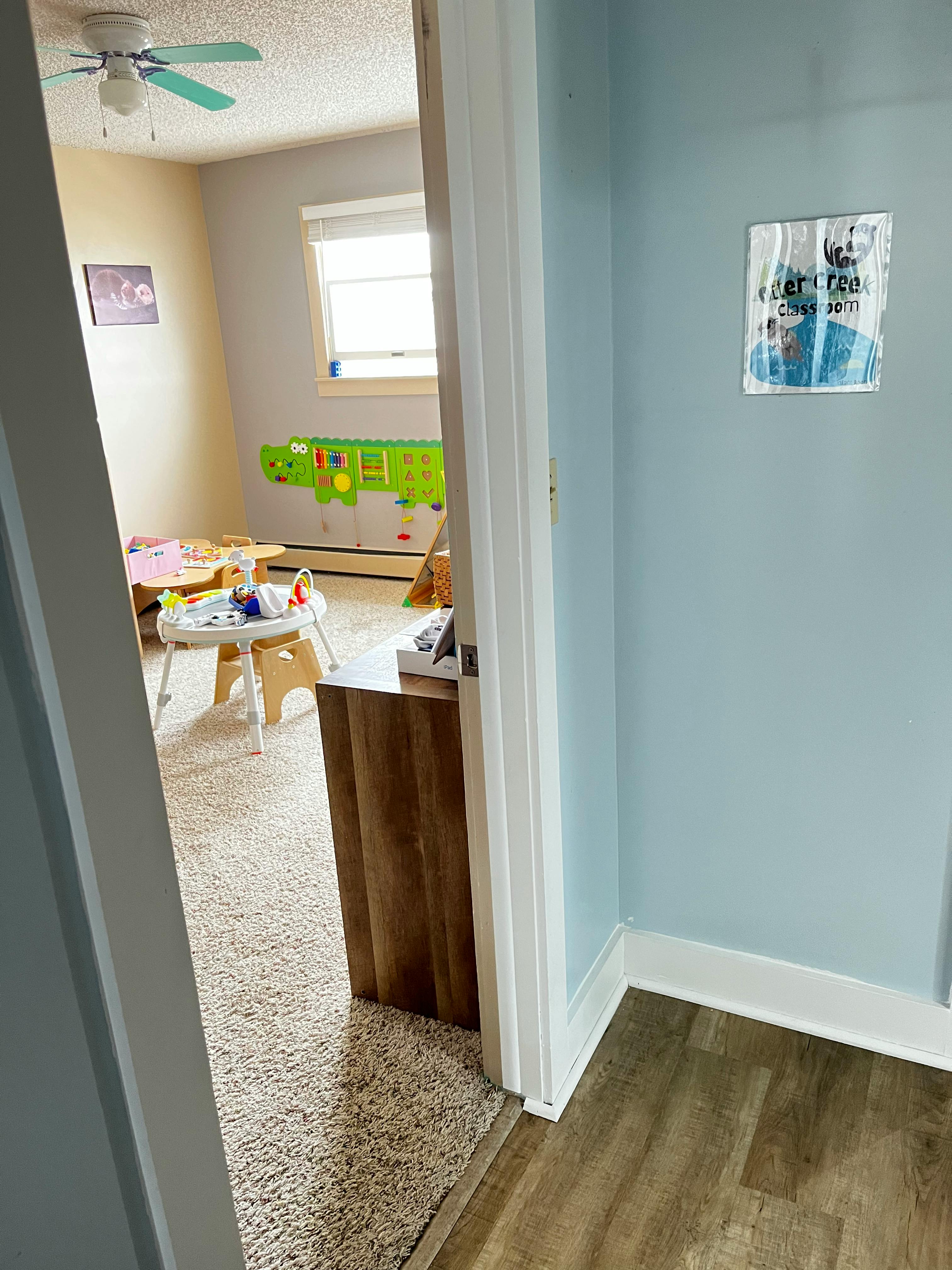 View into a child's room with toys and a window