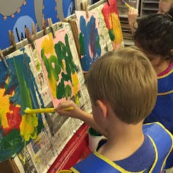 Child painting at an easel
