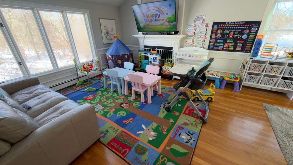Children's play area with a rug, small tables, and various toys