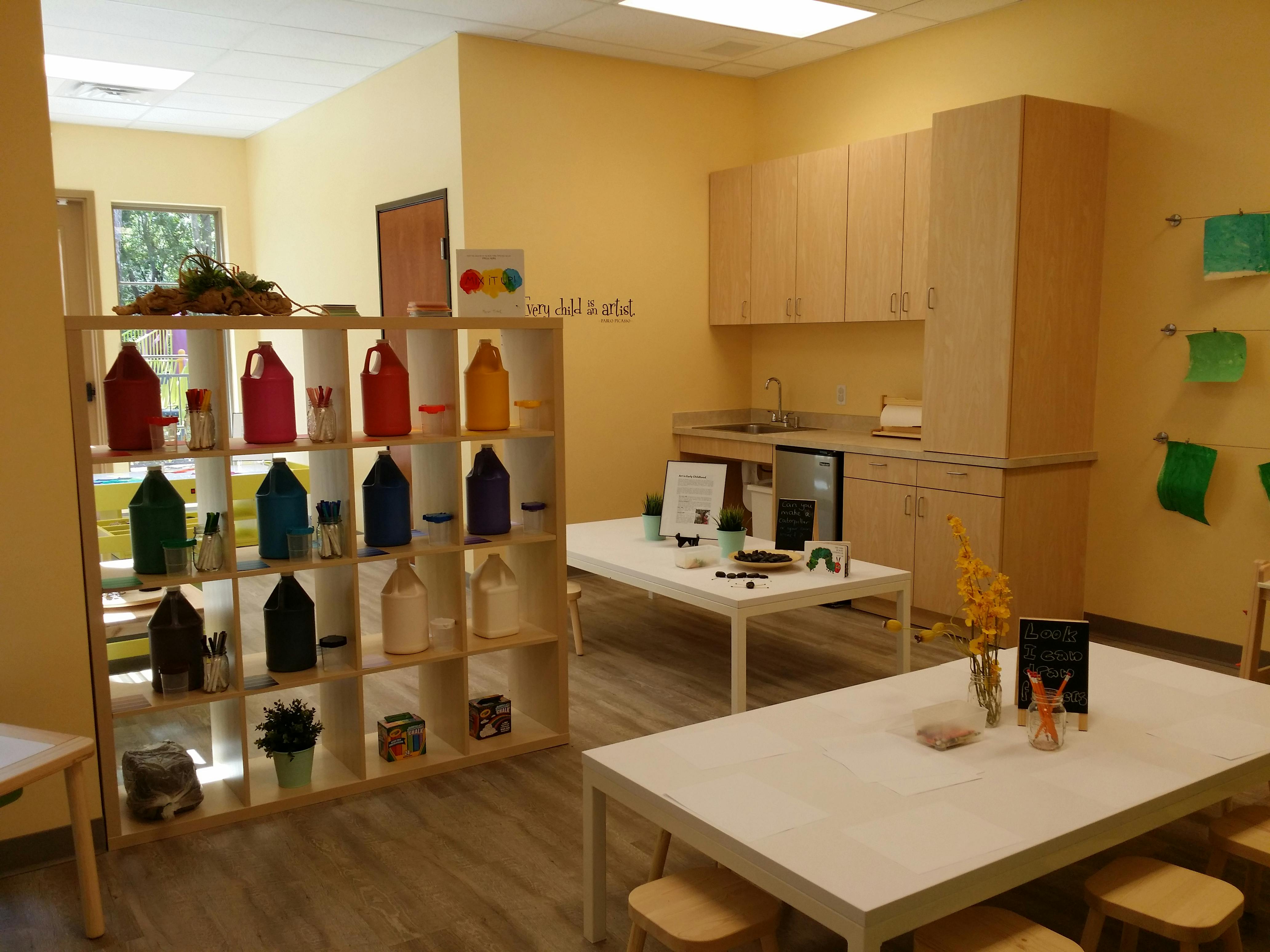 Classroom with shelves of colorful objects and tables