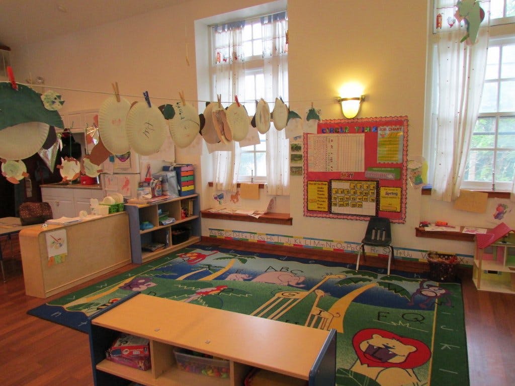 Classroom with a colorful rug, windows, and decorations