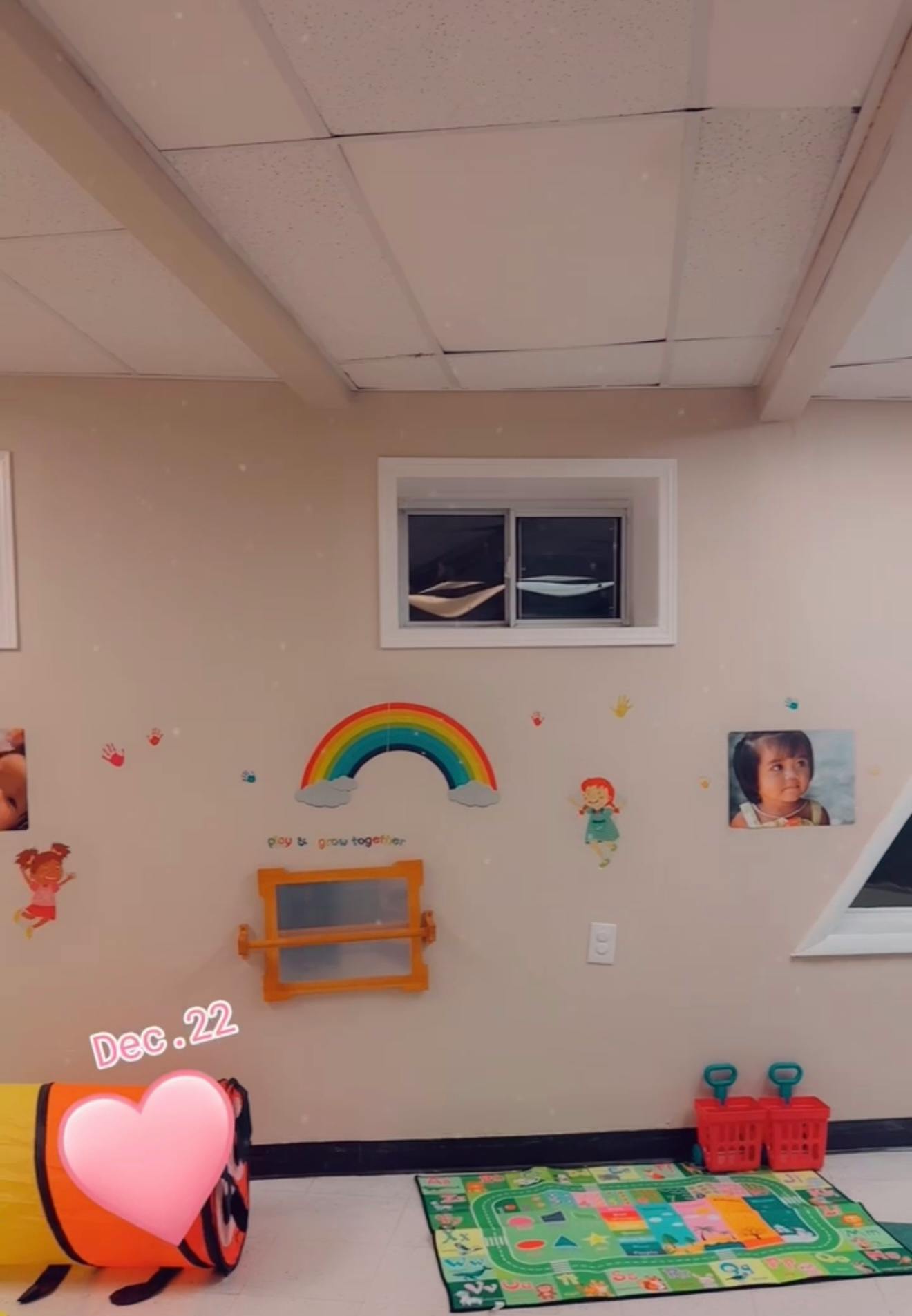 Playroom with a rainbow decoration, blackboard, and colorful rug