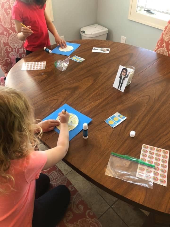 Children drawing and crafting at a wooden table