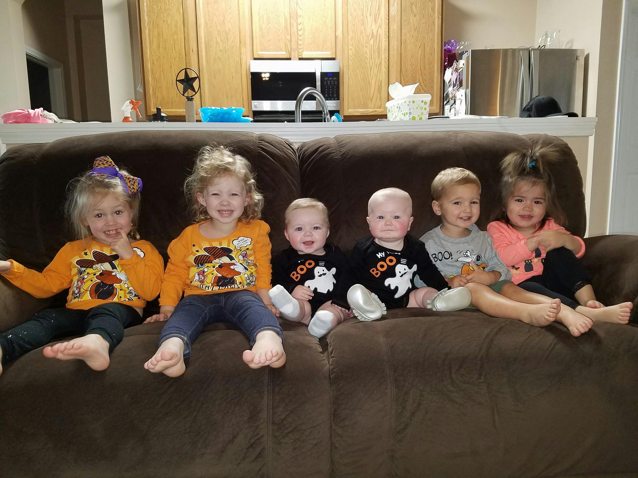 Five children sitting on a couch