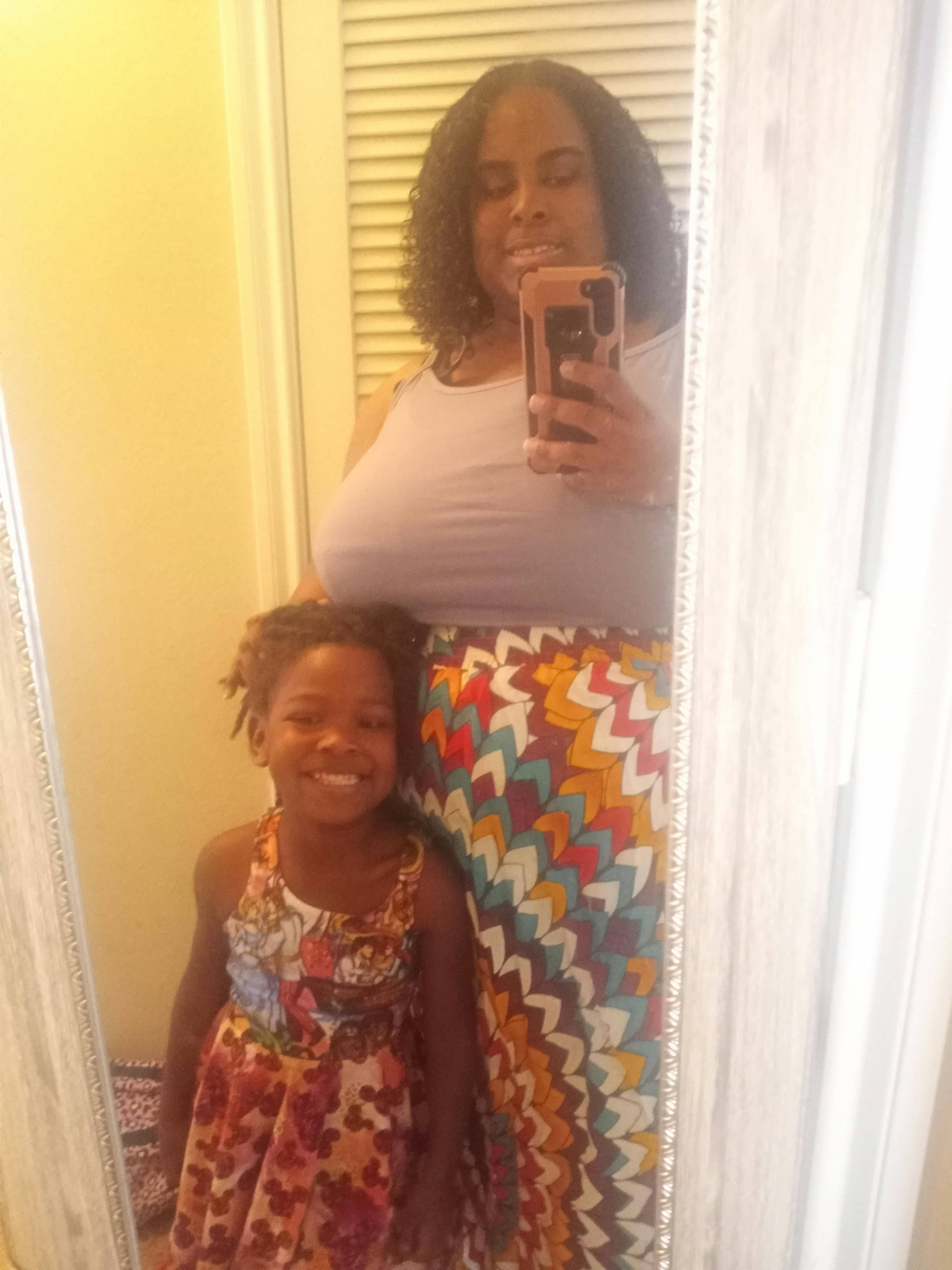 Person taking a mirror selfie with a child