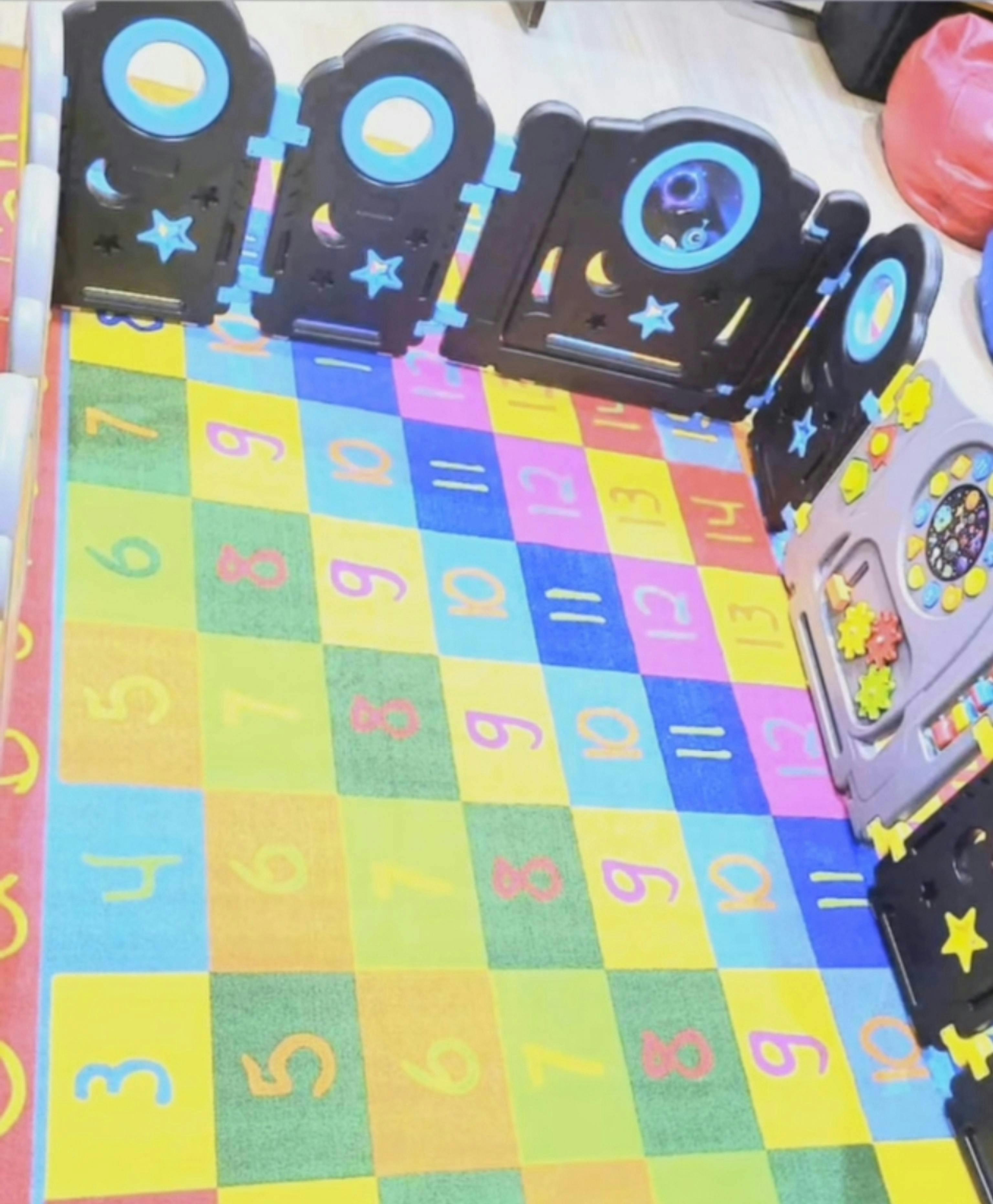 Playpen surrounding a colorful mat with numbers