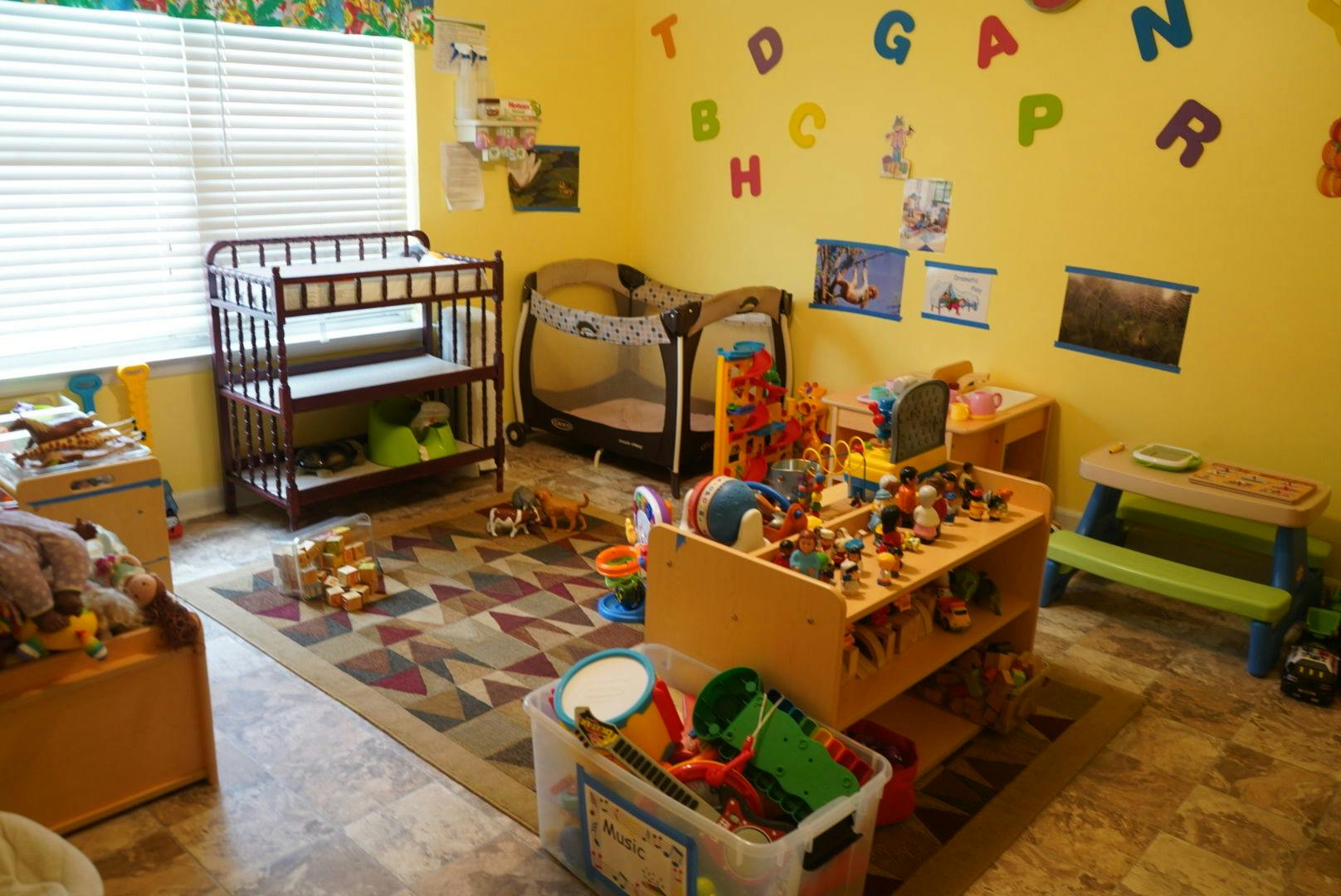 Children's playroom with crib, changing table, and toys