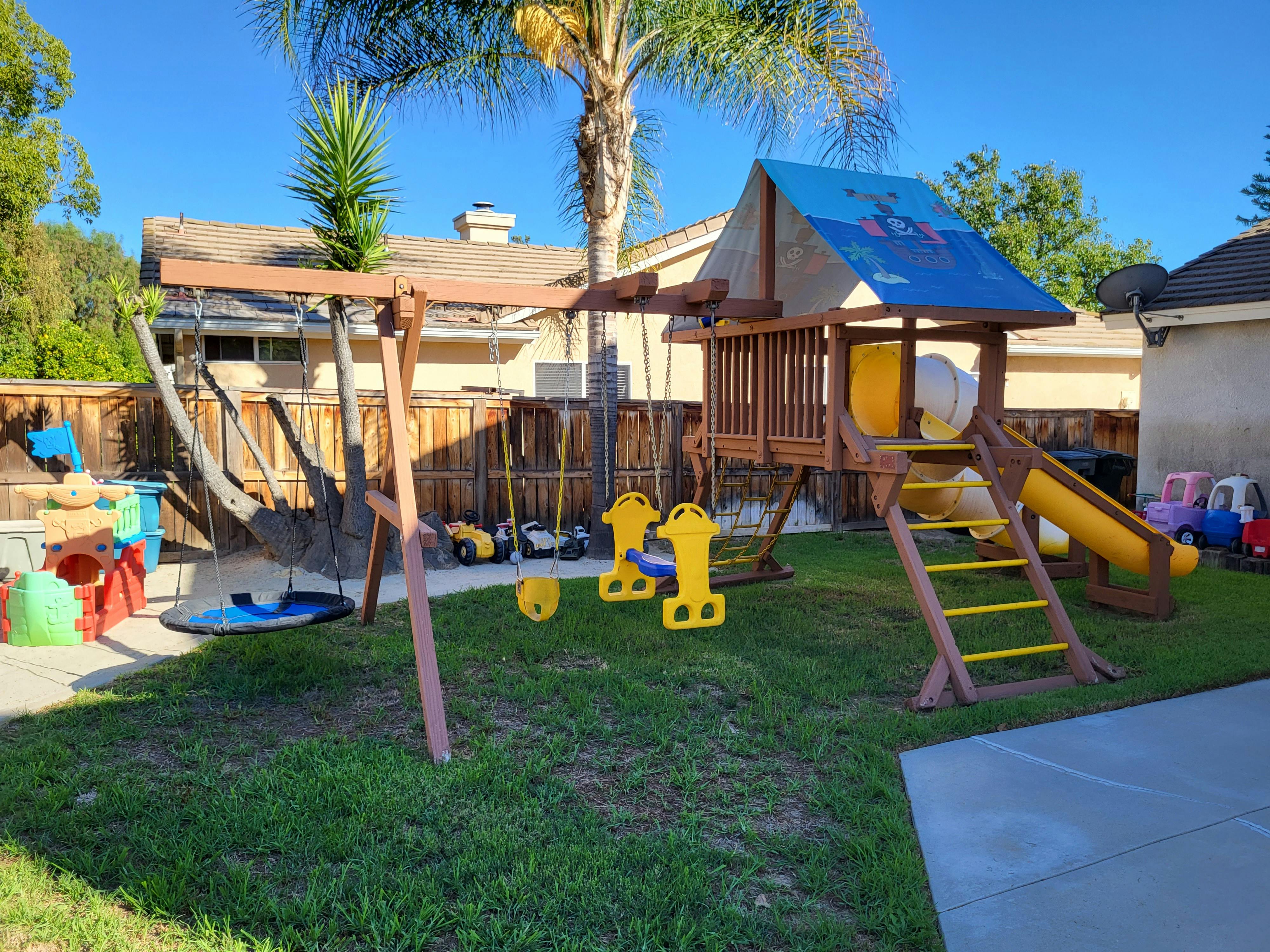 Outdoor playground with swings, slide, and play structure