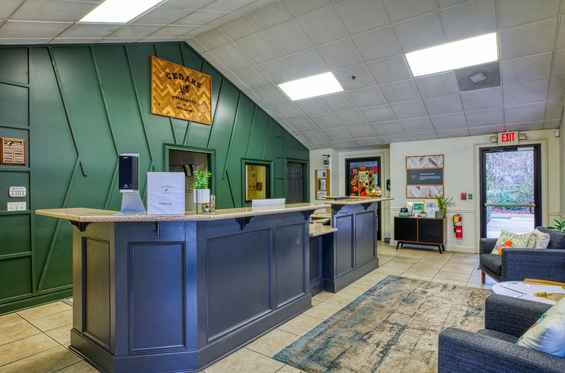 Reception desk inside a preschool with a Cedars Preschool sign