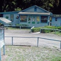 Light blue building with a fence in front