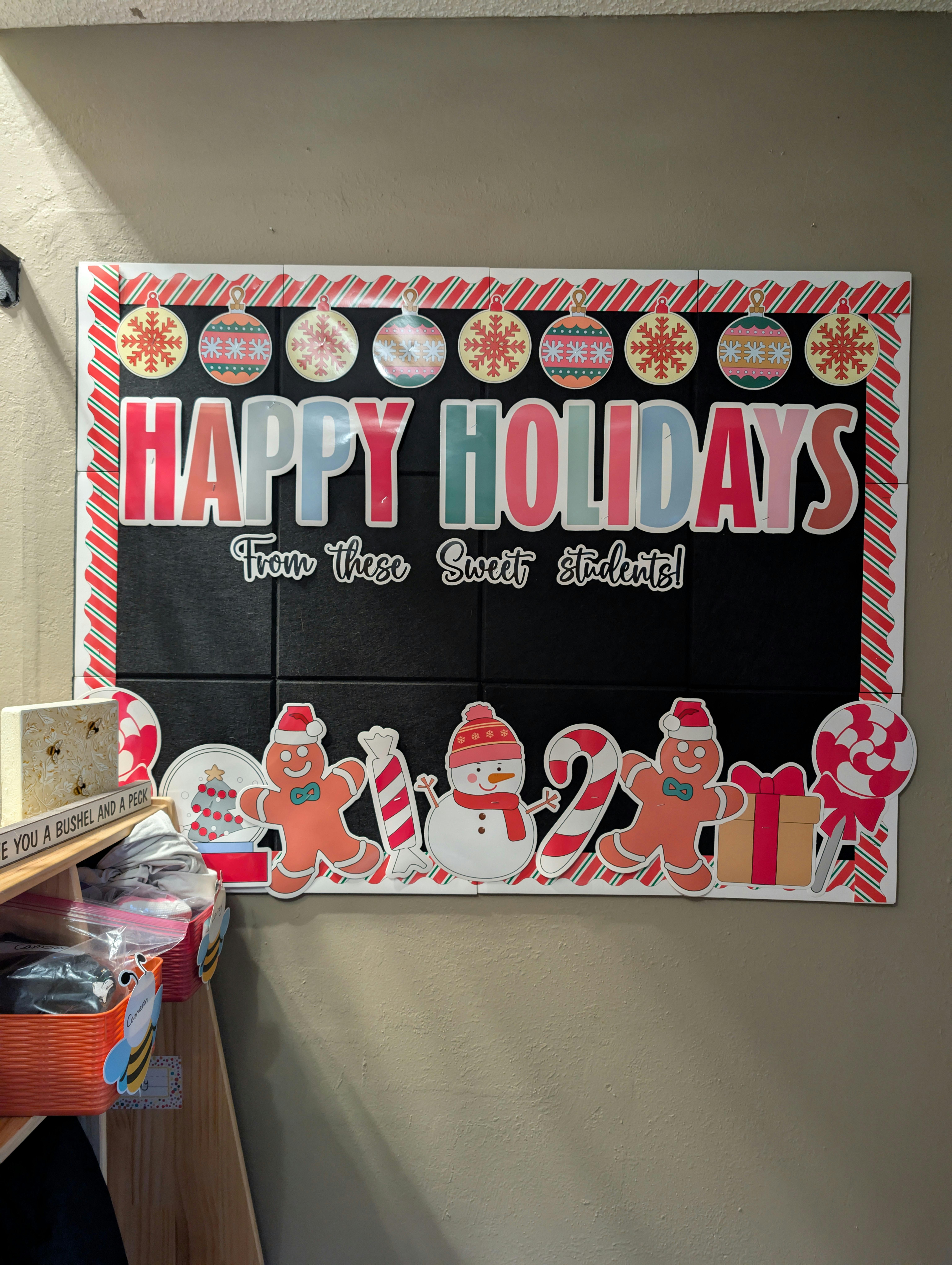 Happy Holidays bulletin board with gingerbread people and snowman decorations